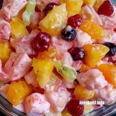 a bowl filled with fruit salad on top of a table