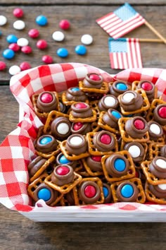 patriotic cookies in a basket with red, white and blue candies on the table