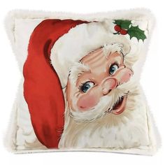 a pillow with a santa claus face on it's side and a holly berry decoration