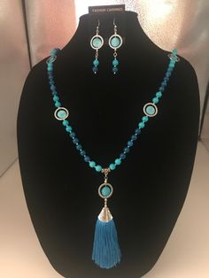 This is the prettiest two tone blue glass bead necklace. It also has a beautiful blue silk tassel pendant that hangs 5 inches. I also added a touch of blue coin beads inside some silver tone rings. All of this together made it just gorgeous. Reminds me of the beautiful blues everyone wears in the summer. I also added a pair of earrings that match perfect. They hang about 3 inches long. Love this piece.  Free gift with every purchase  Anti-tarnish locking bag to store your beautiful jewelry Elegant Blue Necklaces With Dangling Beads, Elegant Blue Beaded Necklace With Dangling Beads, Blue Tasseled Jewelry As Gift, Blue Tasseled Jewelry For Gift, Blue Tassel Jewelry Gift, Blue Tassel Jewelry As Gift, Blue Beaded Necklace With Dangling Czech Glass Beads, Elegant Blue Tassel Necklace Gift, Elegant Blue Tassel Necklace As Gift