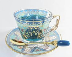 a cup and saucer on a plate with a spoon