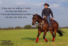 a man riding on the back of a brown horse in a field with a cowboy hat