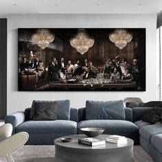 a living room filled with furniture and a large painting on the wall above it's coffee table