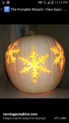 a carved pumpkin with snowflakes on it