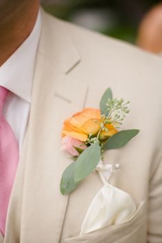 a man in a suit with a boutonniere on his lapel