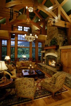 a living room filled with lots of furniture and a fire place in the middle of it