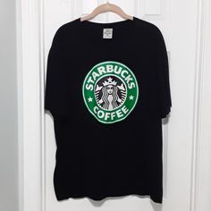 Only Worn Twice! Still In Brand New Condition! Black Starbucks Coffee Tee Shirt. 100% Cotton With Short Sleeves And Crew Neck. 28 In From Shoulder To Bottom Hem. 23 In Across Chest From Armpit To Armpit Laying Flat Coffee Tees, Starbucks Coffee, Woman Painting, Tee Shirts, Short Sleeves, Womens Tops, Women Shopping, Black