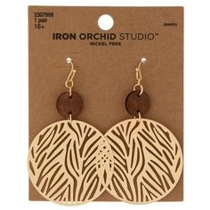 pair of wooden earrings with an animal print pattern on the front and back of each ear