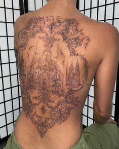 the back of a woman with tattoos on her body