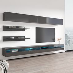 a modern living room with white walls and grey entertainment center on the wall, built in bookshelves