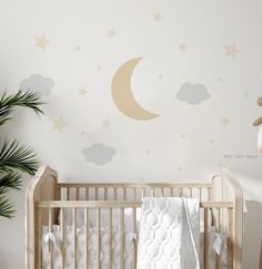 a baby's room with a crib and wall decals