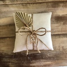 a small pillow with a decorative fan on it's back and tied in twine