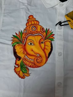 an elephant painted on the back of a white shirt