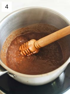 a wooden spoon stirring chocolate in a pot