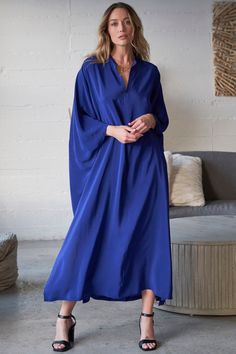 Experience laid-back glamour with our cobalt blue silk caftan. Featuring a delicate collar, back pleat, and side slits, it offers effortless elegance. Shop Now! Talitha Getty, Silk Caftan, Caftan Tunic, Loungewear Dress, Kaftan Designs, Gauze Dress, By The Ocean, Feeling Blue, Effortless Elegance