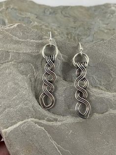 These beautiful Celtic drop earrings are truly unique.   They are made completely by hand with fine silver.  I was inspired to create these by the many different Celtic braids and knotwork  in Irish culture and felt these were a good interpretation with a modern twist. Pleasingly simple yet extraordinary, these earrings can be worn dressed up or down. They are extremely versatile and will compliment any outfit as well as get you compliments whenever you wear them.  MATERIALS•  Fine Silver •  Ear Handmade Spiral Sterling Silver Wrap Earrings, Spiral Silver Plated Wire Earrings As Gift, Spiral Silver Plated Wire Earrings For Gift, Unique Spiral Silver Earrings, Handmade Sterling Silver Linear Earrings For Gifts, Handmade Silver Drop Wrap Earrings, Handmade Sterling Silver Linear Earrings Gift, Spiral-shaped Single Sterling Silver Earring, Unique Silver Spiral Earrings