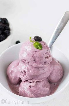 a white bowl filled with blueberries and ice cream