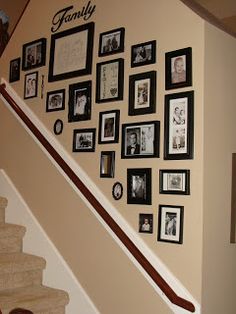 the staircase wall is decorated with family pictures and framed photos on it's side