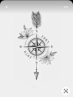 a black and white photo of a compass with flowers on the front, and leaves on the back