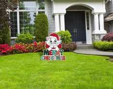 a lawn with a house and trees in the background that says merry christmas on it