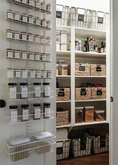 an organized pantry with lots of baskets and containers on the shelves in front of it