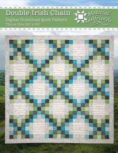 a green and blue quilt on top of a grass covered field with the words double irish chain