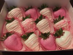 a box filled with pink and white chocolate covered strawberries