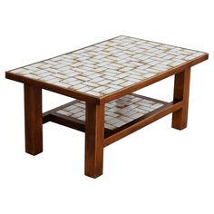 a coffee table with white and brown tiles on it's top, against a white background