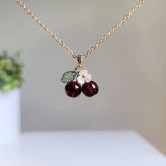 🍒Material: Our sweet cherry necklaces are handmade with glass cherries, acrylic flowers, acrylic leaves and 14K gold plated(hypoallergenic) chains. This necklace is a great match for our cherry earrings. The silver version is available as well. Please contact us for details.🌺 Size: the cherry pendant is about (W x L) 0.6" and 0.75". Can't find your perfect chain length? We offer different length options, 16-inch, 18-inch, 20-inch, 24-inch and 36-inch. Affordable Elegant Cherry Earrings, Handmade Cherry Jewelry For Gift, Cute Red Flower Jewelry, Cherry Color Trendy Nickel-free Jewelry, Trendy Cherry Nickel-free Jewelry, Cherry Nickel-free Trendy Jewelry, Cute Cherry-colored Jewelry For Gifts, Cute Cherry-colored Jewelry Gift, Trendy Handmade Cherry Jewelry