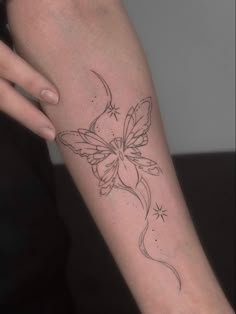 a woman's arm with a butterfly tattoo on the left side of her body