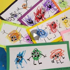 children's handprinted pictures with eyes and hands on them are displayed in front of