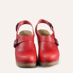 Make a statement with the Astrid slingback clog in red. Astrid has the form of a traditional Swedish clog, but the cross-over strap and double buckle detail bring it bang up to date. Handcrafted in Portugal from the finest leather, the Astrid clog will bring a pop of color and style to any outfit. Adjustable straps over the instep and behind the heel ensure a perfect fit. Flexible sole with woodlike effect Heel 7,5 cm /2,95 in Normal fit Swedish Clogs, Red Cedar Wood, Heel Grips, Red High, Shoes Too Big, Shoe Tree, Shoe Store, Cobbler, Shoe Box