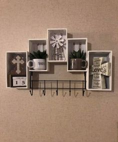 a wall mounted shelf with pictures and mugs on it