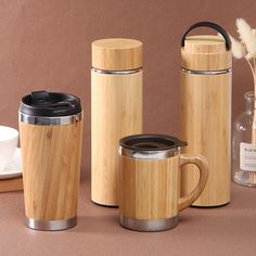 three bamboo coffee mugs and one teapot