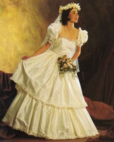 a woman in a wedding dress posing for a photo