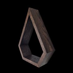 a wooden object is shown in the middle of a black background and it looks like an octagon