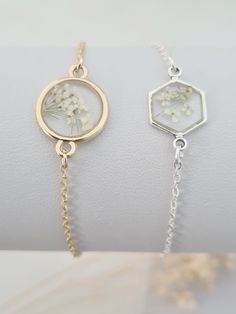 Pretty and dainty bracelet featuring real pressed Queen Anne's Lace.  Tiny off white flowers tiny set in resin. The flower is set in round gold plated setting measuring 22mm in diameter or silver plated hexagonal setting (including the loops for the chain). This bracelet will arrive in a bag ready for giving. Delicate Adjustable Jewelry With Pressed Flowers, Adjustable Round Bracelets With Pressed Flowers, Adjustable Bracelets With Pressed Flowers, Adjustable Flower Bracelets With Pressed Flowers, Adjustable Birth Flower Bracelet For Wedding, Delicate Birth Flower Bracelet, Bridesmaid Bracelet Flower, Resin Flower Jewelry, Young Enterprise