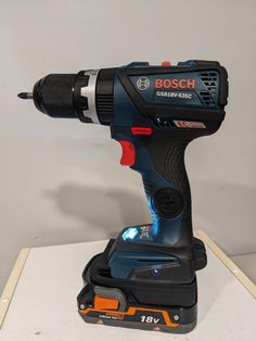 a cordless drill is sitting on top of a box