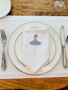 a place setting with silverware and napkins