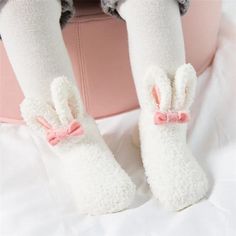 Embrace the coziness of winter with our adorable Bunny Baby Socks, designed to keep your little one's feet warm and stylish. Perfect for indoor lounging or outdoor adventures, these socks feature a soft, fluffy exterior and lining, ensuring maximum warmth and comfort. Adorned with a cute bunny face and ears on the top, a bow at the front, and playful pom poms, these socks are as charming as they are practical.Made with a cozy fleece material, these socks provide a soft and gentle touch against your baby's skin, keeping their feet warm and snug during the colder monthsThe socks boast a delightful bunny face and ears on the top, bringing a whimsical touch to your baby's winter wardrobe.A cute bow at the front and pom poms at the opening add playful elements to the socks, making them a joy to Bunny Ears And Tail, Vogue Kids, Bunny Slippers, Fluffy Bunny, Toddler Socks, Rabbit Baby, Pink Socks, Bunny Face