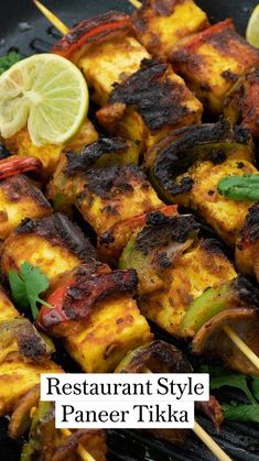 grilled tofu and smoky paneer tikka on a grill with lime wedges