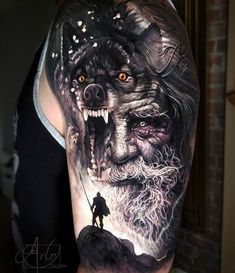 a man's arm with tattoos on it and an image of a wolf in the background