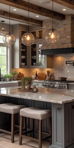 a kitchen with two stools next to an island in the middle of the room