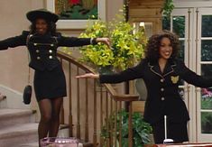 two women dressed in uniforms are dancing on the set of tv show friends like us