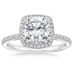 a cushion cut diamond engagement ring with pave set shoulders