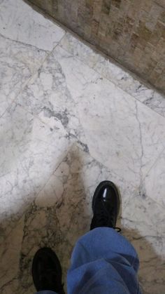 a person standing on top of a marble floor