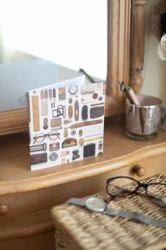 a close up of a card on a table near a pair of eyeglasses