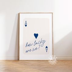 a framed poster with the words how lucky are we? on it in blue ink