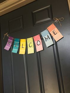 a welcome sign is hanging on the front door for someone's house to welcome