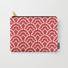 a red and white pattern carry - all pouch